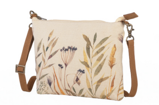 Verdant sling canvas bag with long removable strap. Leather trim, zipper and pockets. Floral wildflowers in neutral tones.